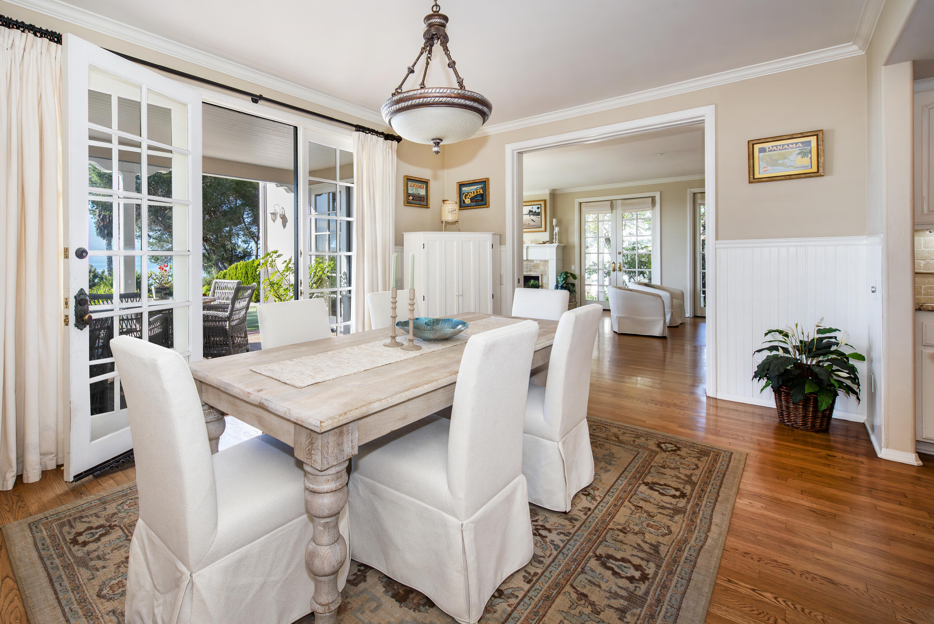 2525 Emerson Street Summerland, CA 93067 - Photo 7 of 26 a dining room with furniture wooden floor a rug a potted plant and a chandelier
