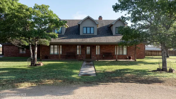 a front view of a house with a yard table and chairs