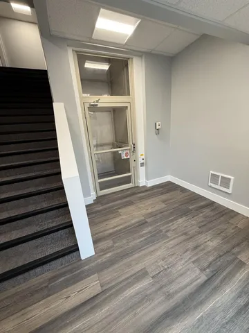 a view of a hardwood floor and staircase