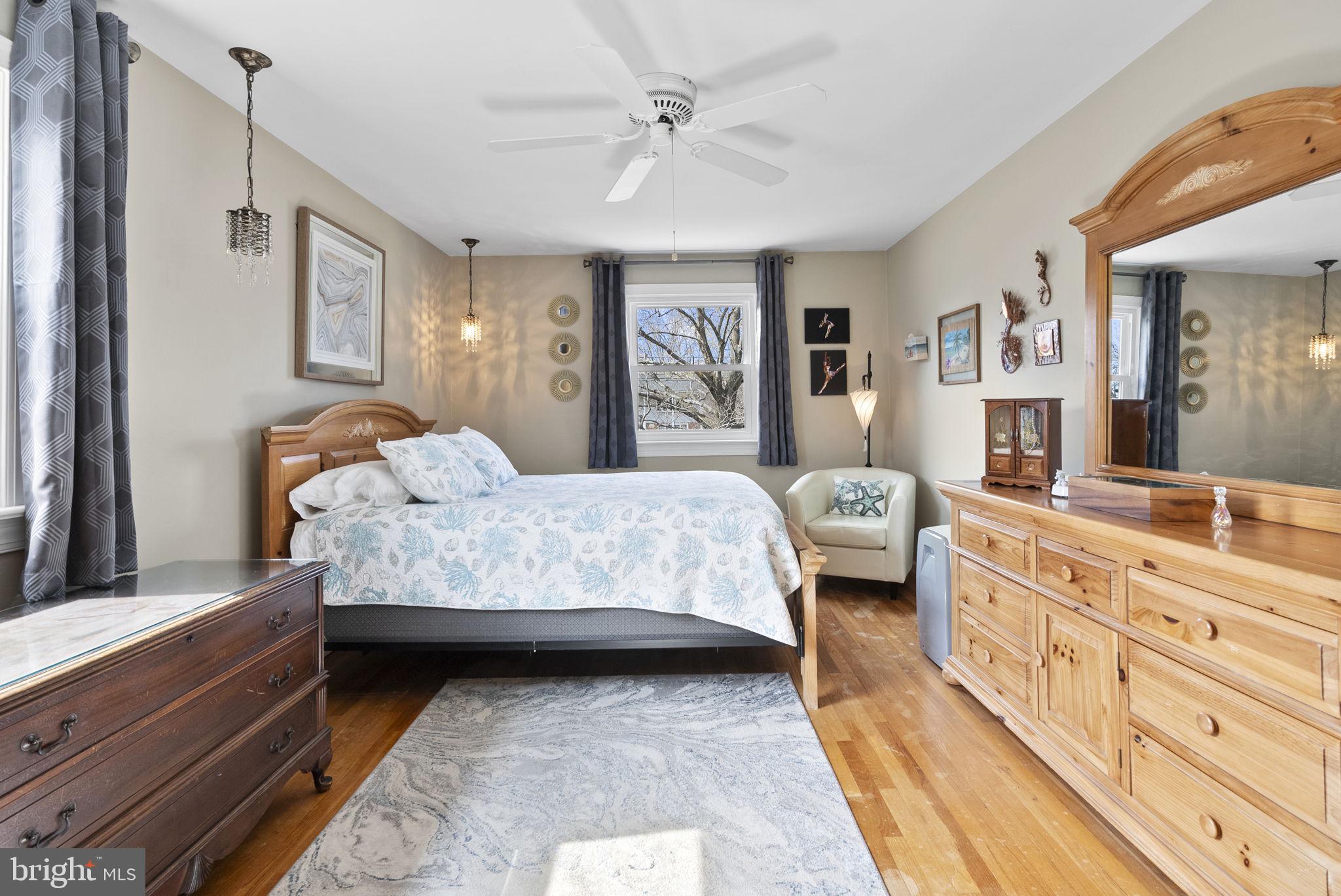 222 Brookside Circle Harleysville, PA 19438 - Photo 19 of 34 a bedroom with a large bed and a chandelier