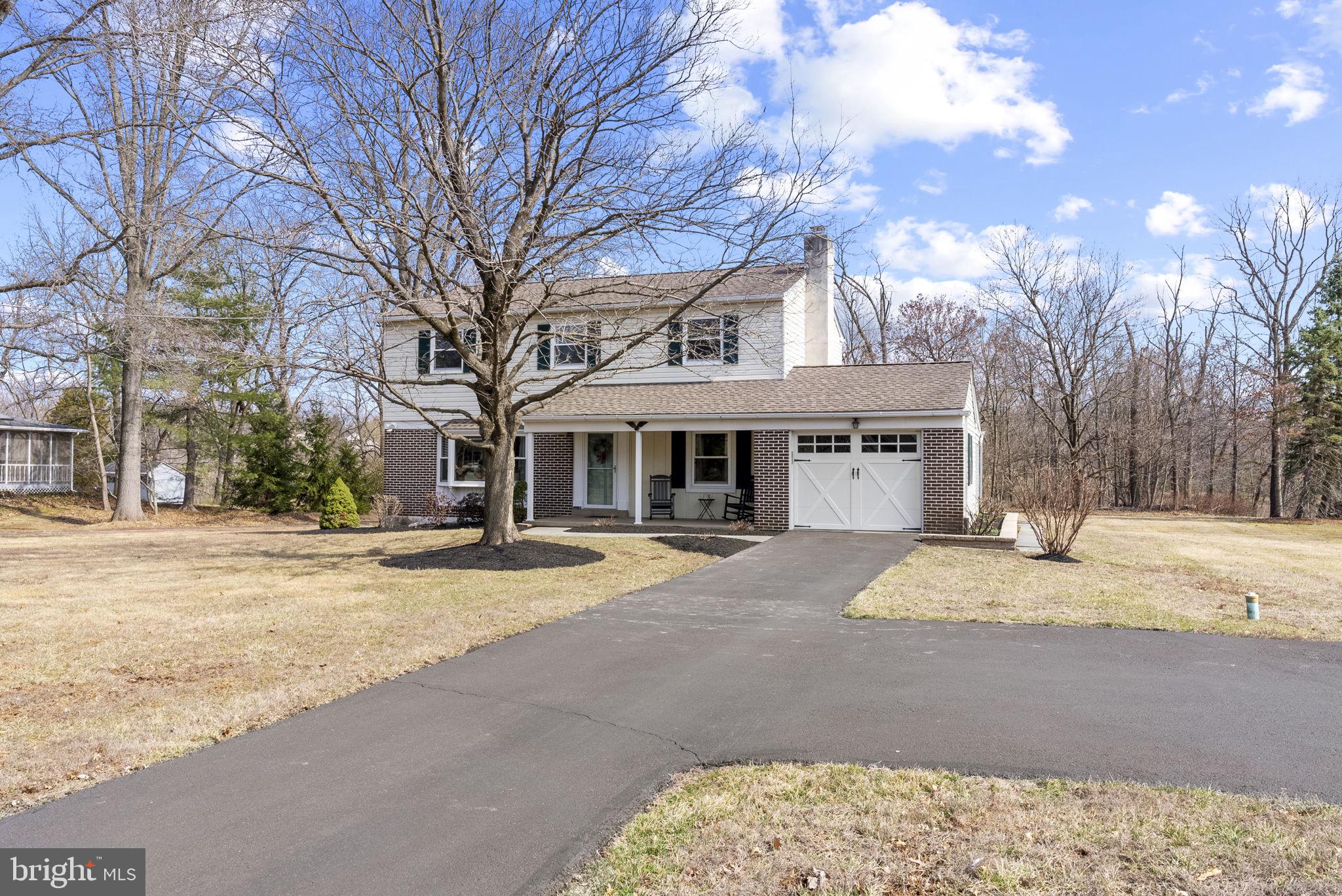 222 Brookside Circle Harleysville, PA 19438 - Photo 29 of 34 a front view of house with yard slide and trees