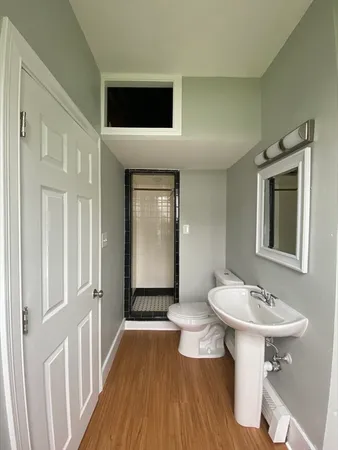 a bathroom with a sink a mirror and a toilet
