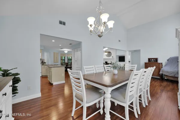 a living room with furniture dining room and wooden floor