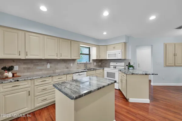 a living room with furniture a clock and a fireplace