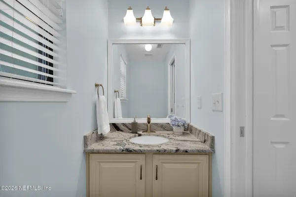 a bathroom with a sink and a mirror