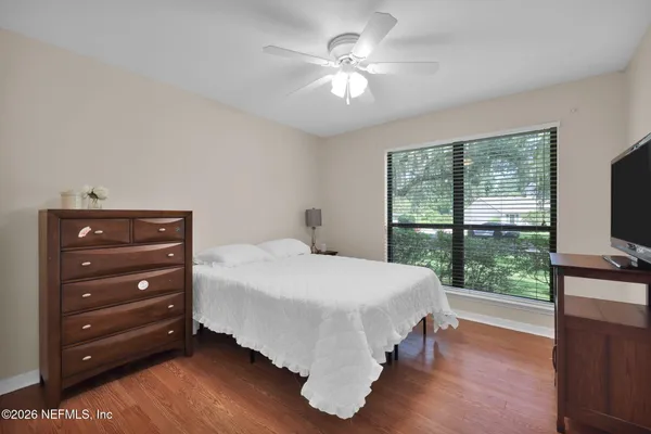 a view of a house with a big yard and large trees