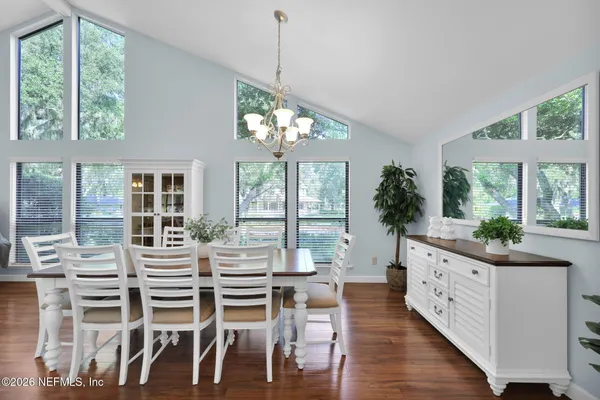 a living room with furniture a clock and a fireplace