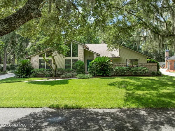 an aerial view of residential houses with outdoor and green space