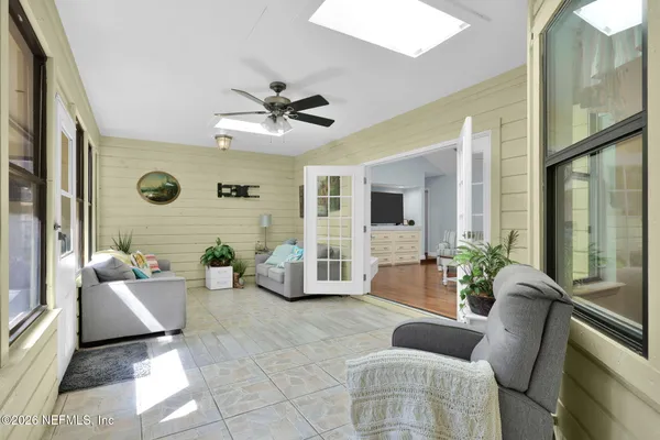 a kitchen with stainless steel appliances granite countertop wooden cabinets a sink a stove a dining table and chairs