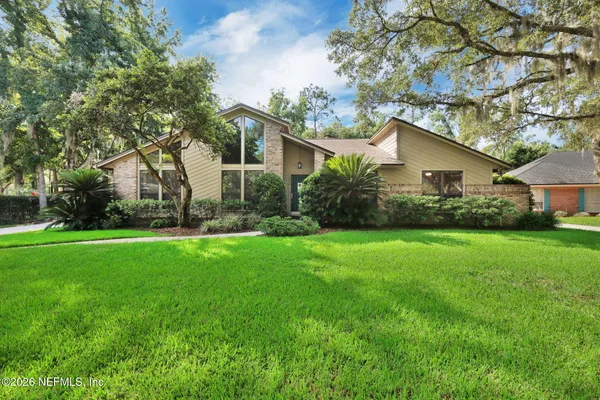 a front view of house with yard and green space