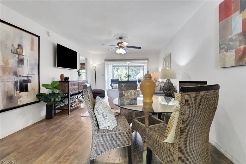 1021 3rd Street South, Unit 306 Naples, FL 34102 - Photo 14 of 24 a view of a dining room with furniture and wooden floor