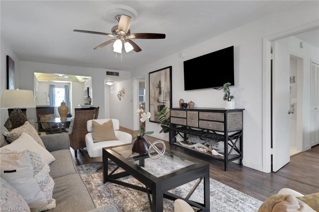 1021 3rd Street South, Unit 306 Naples, FL 34102 - Photo 17 of 24 a living room with furniture and a flat screen tv