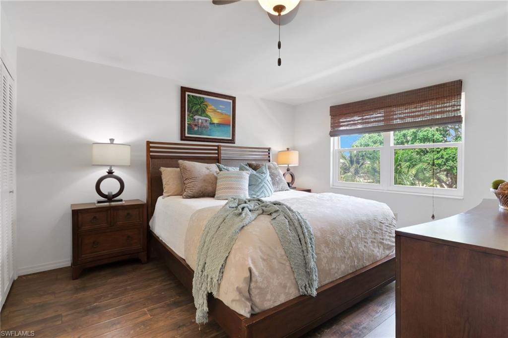 1021 3rd Street South, Unit 306 Naples, FL 34102 - Photo 18 of 24 a bedroom with a bed and a night stand