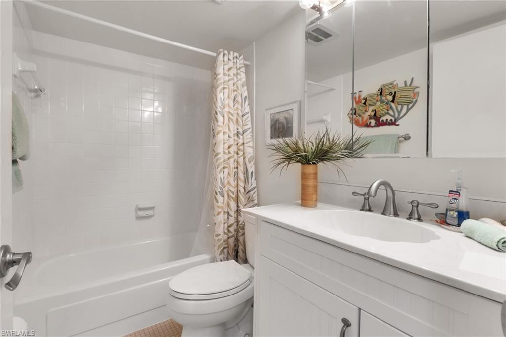 1021 3rd Street South, Unit 306 Naples, FL 34102 - Photo 23 of 24 a bathroom with a sink a toilet and shower