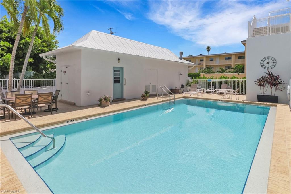 1021 3rd Street South, Unit 306 Naples, FL 34102 - Photo 24 of 24 a swimming pool with outdoor seating and yard