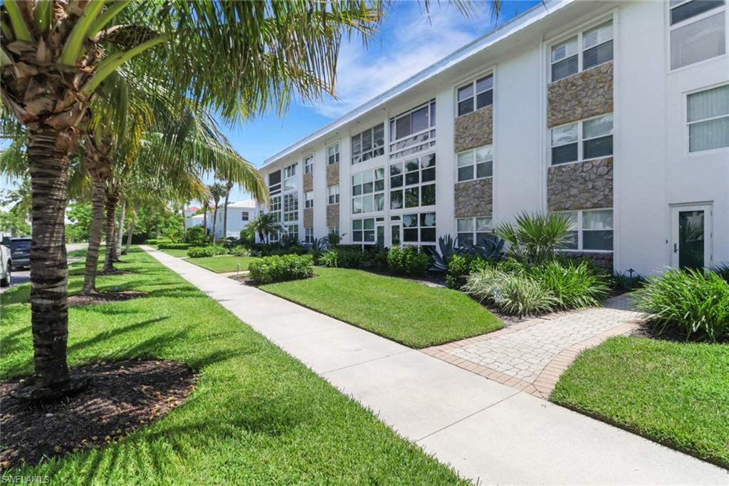 1021 3rd Street South, Unit 306 Naples, FL 34102 - Photo 7 of 24 a front view of a building with garden
