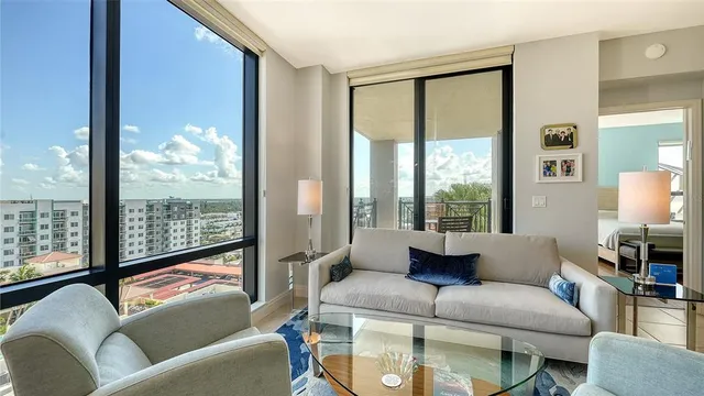 a dining room with furniture a chandelier and window