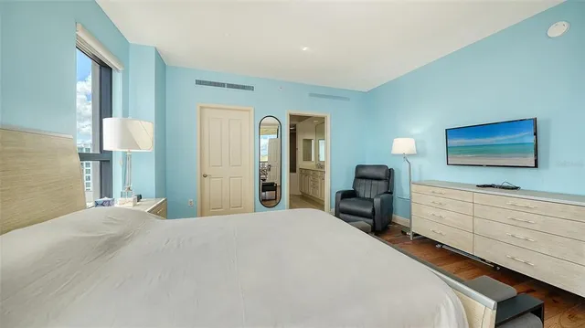 a bedroom with a bed couch and window