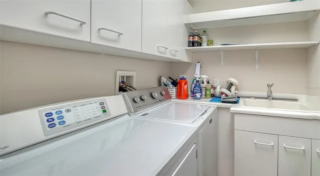 a living room with furniture a fireplace and a potted plant
