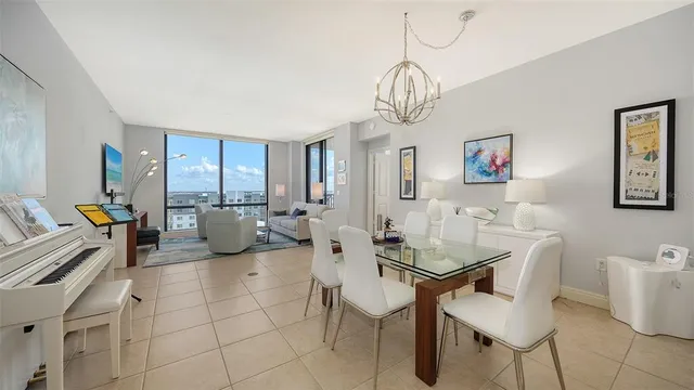 a view of a dining room with furniture a chandelier and wooden floor