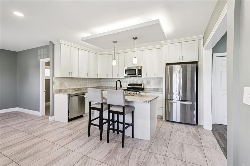 5256 Wickliff Street Pittsburgh, PA 15201 - Photo 11 of 49 a kitchen with a refrigerator a microwave and cabinets