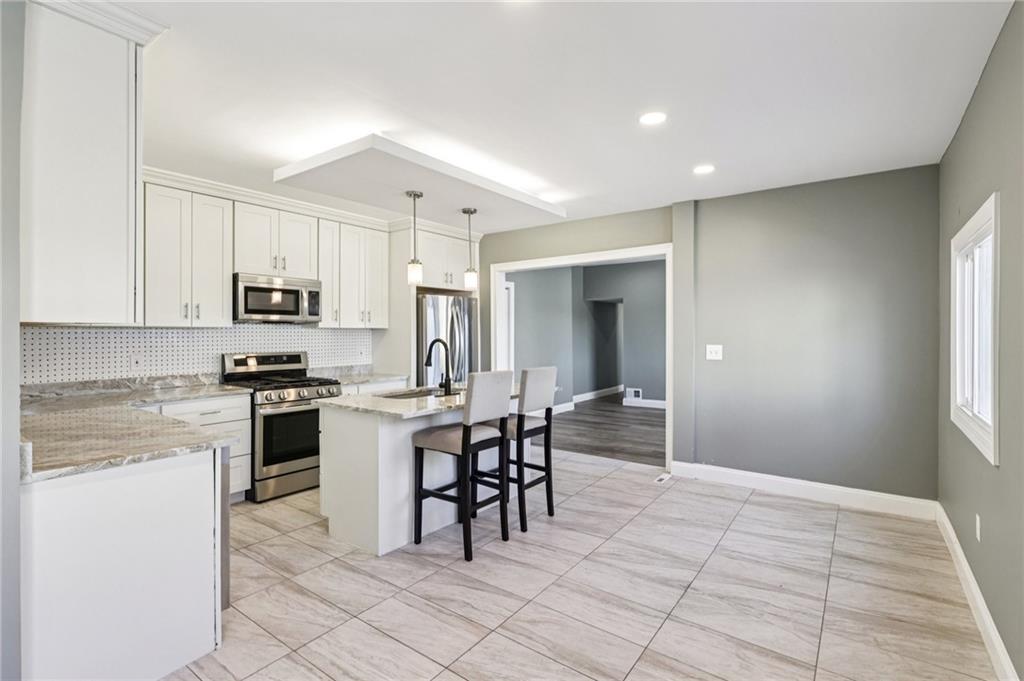5256 Wickliff Street Pittsburgh, PA 15201 - Photo 12 of 49 a kitchen with cabinets and chairs
