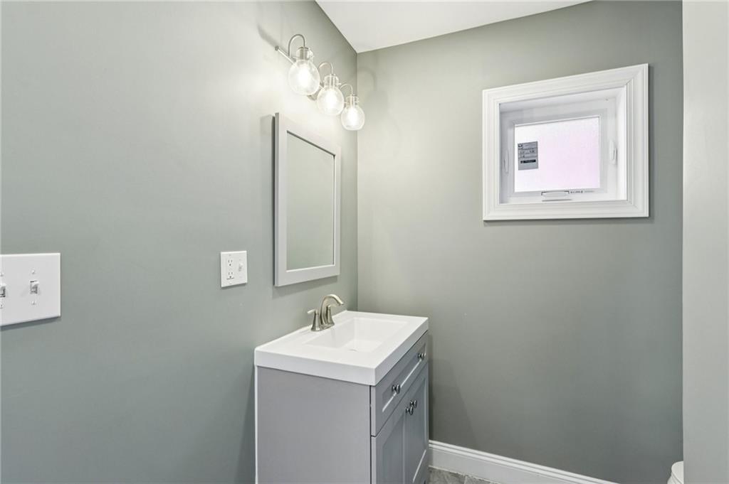 5256 Wickliff Street Pittsburgh, PA 15201 - Photo 20 of 49 a bathroom with a sink and a mirror