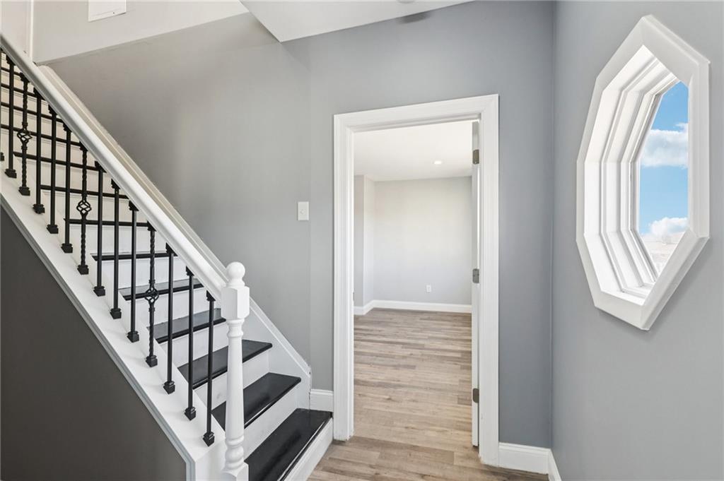 5256 Wickliff Street Pittsburgh, PA 15201 - Photo 21 of 49 a view of a hallway with wooden floor and staircase