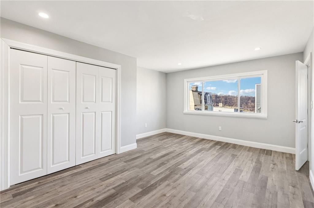 5256 Wickliff Street Pittsburgh, PA 15201 - Photo 23 of 49 an empty room with wooden floor closet and windows
