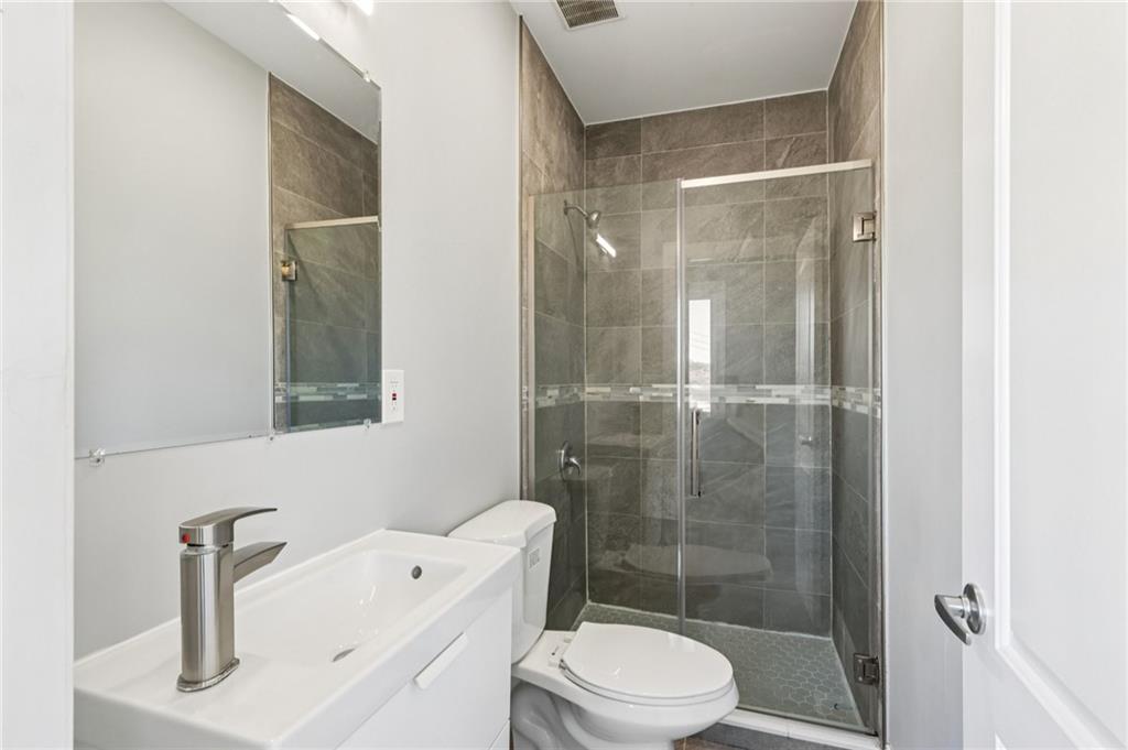 5256 Wickliff Street Pittsburgh, PA 15201 - Photo 24 of 49 a bathroom with a sink a toilet and shower