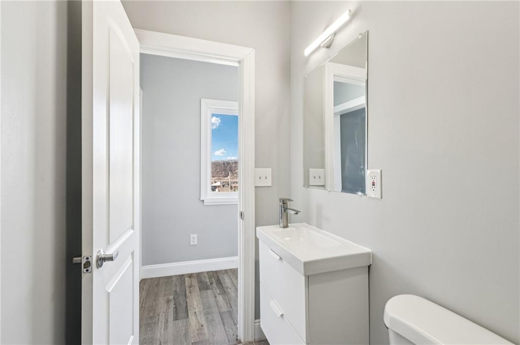 5256 Wickliff Street Pittsburgh, PA 15201 - Photo 25 of 49 a bathroom with a sink toilet and vanity