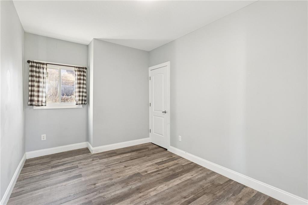 5256 Wickliff Street Pittsburgh, PA 15201 - Photo 26 of 49 a view of an empty room with wooden floor and a window