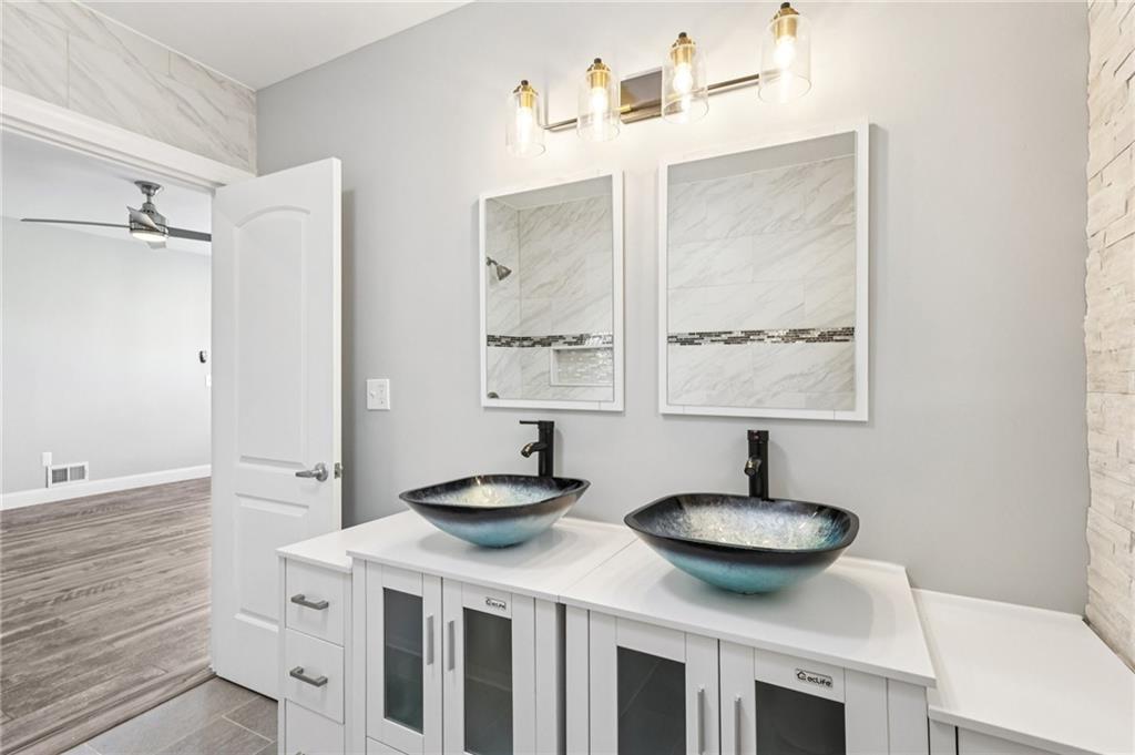 5256 Wickliff Street Pittsburgh, PA 15201 - Photo 33 of 49 a bathroom with a double vanity sink and a mirror