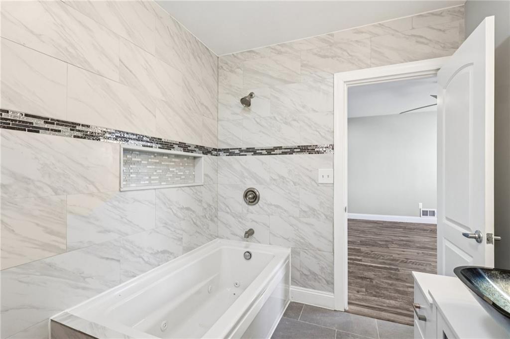 5256 Wickliff Street Pittsburgh, PA 15201 - Photo 34 of 49 a bathroom with a bathtub and shower