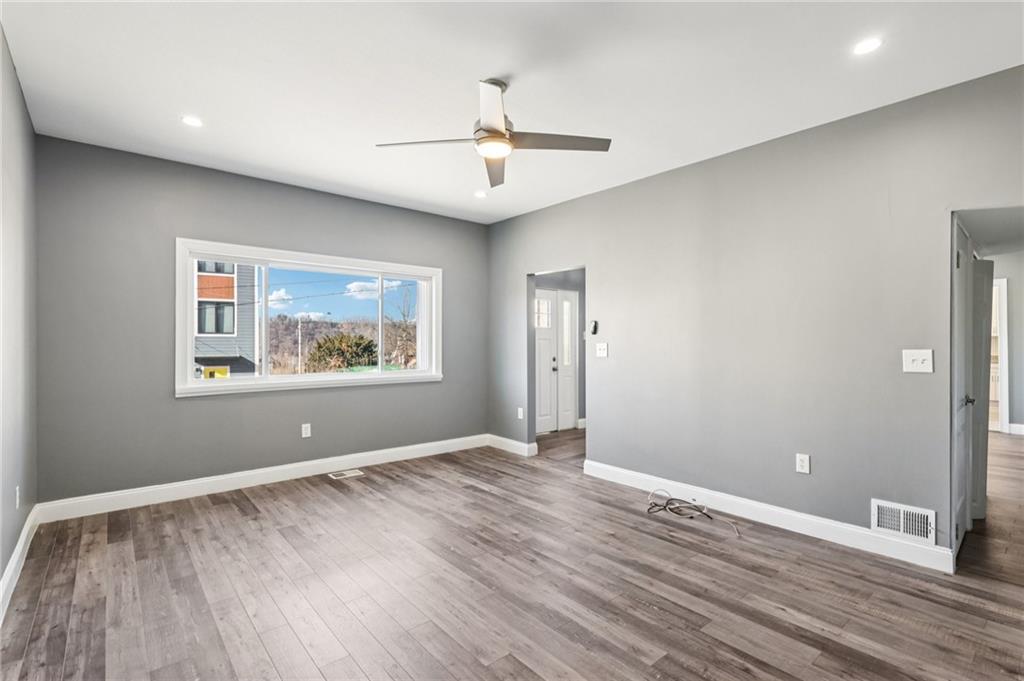 5256 Wickliff Street Pittsburgh, PA 15201 - Photo 6 of 49 wooden floor in an empty room with a window