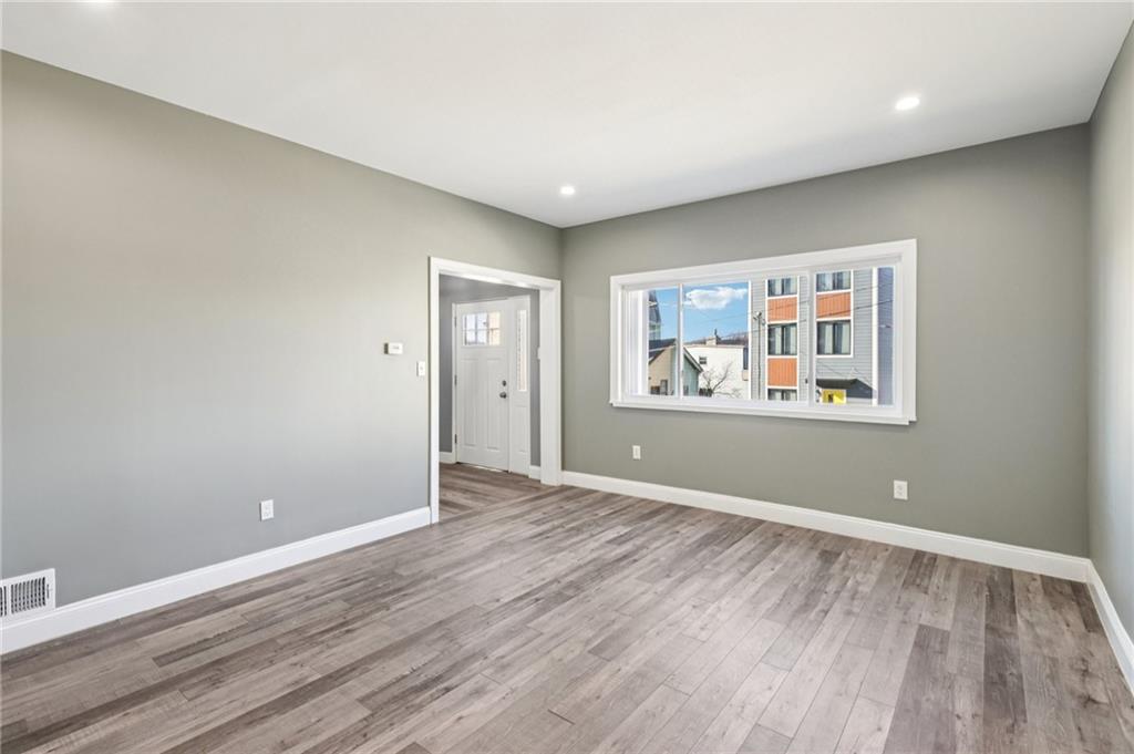 5256 Wickliff Street Pittsburgh, PA 15201 - Photo 9 of 49 a view of a room with wooden floor and window