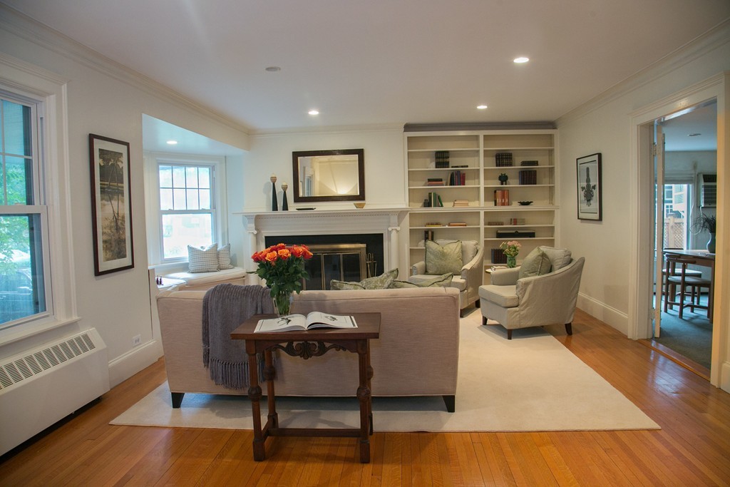 51 Salisbury Road Brookline, MA 02445 - Photo 2 of 7 a living room with furniture wooden floor and a fireplace