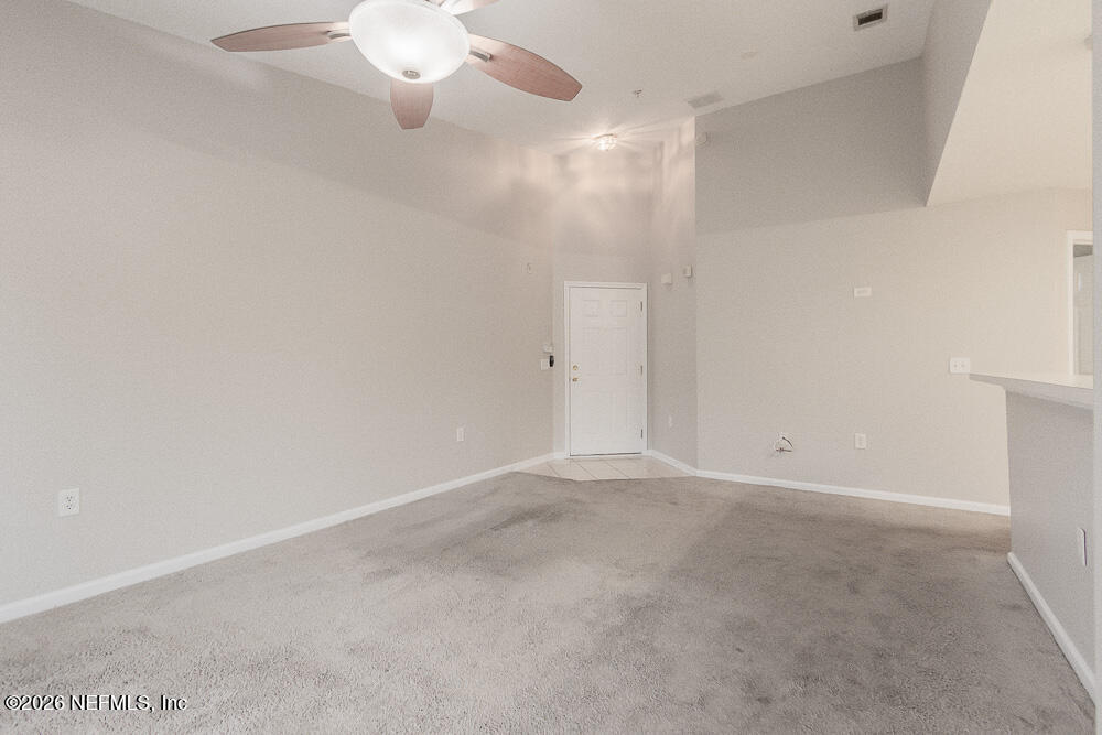 7920 Merrill Road, Unit 1511 Jacksonville, FL 32277 - Photo 11 of 32 a view of an empty room with a chandelier fan
