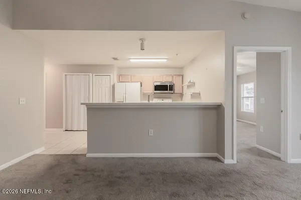 a kitchen with stainless steel appliances a refrigerator and a stove top oven