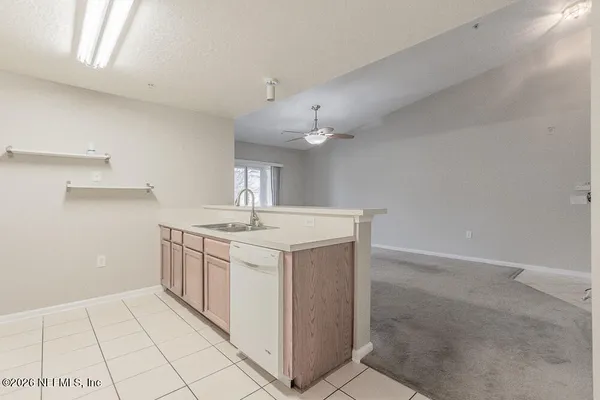 a kitchen with white cabinets stainless steel appliances and sink