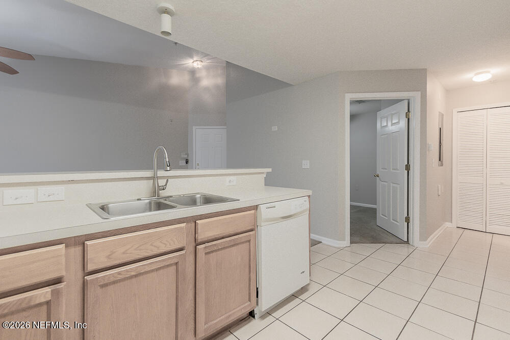 7920 Merrill Road, Unit 1511 Jacksonville, FL 32277 - Photo 16 of 32 a bathroom with a sink and a mirror