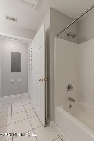an empty room with a fan and a fan