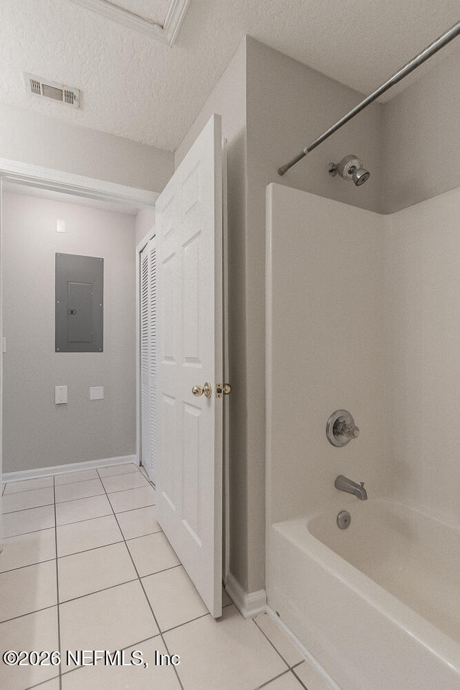 7920 Merrill Road, Unit 1511 Jacksonville, FL 32277 - Photo 20 of 32 a bathroom with a bathtub and shower