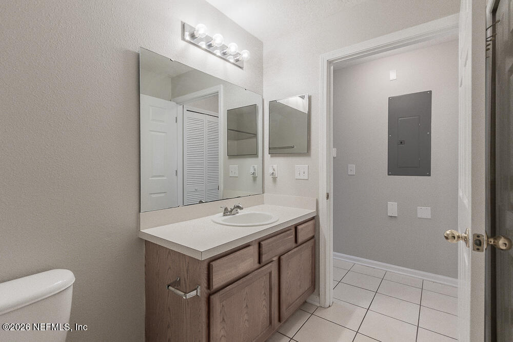 7920 Merrill Road, Unit 1511 Jacksonville, FL 32277 - Photo 21 of 32 a bathroom with a sink a toilet and mirror
