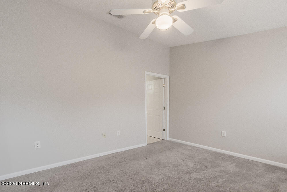 7920 Merrill Road, Unit 1511 Jacksonville, FL 32277 - Photo 24 of 32 an empty room with a fan and a fan