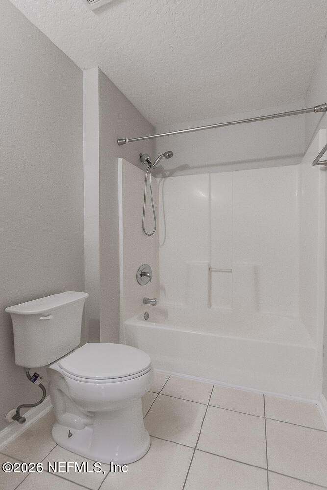 7920 Merrill Road, Unit 1511 Jacksonville, FL 32277 - Photo 26 of 32 a bathroom with a toilet and a shower