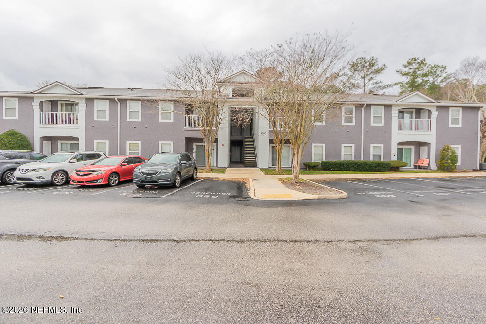 7920 Merrill Road, Unit 1511 Jacksonville, FL 32277 - Photo 6 of 32 a building with cars parked in front of it