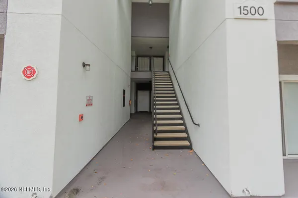 an empty room with a ceiling fan and a bathroom