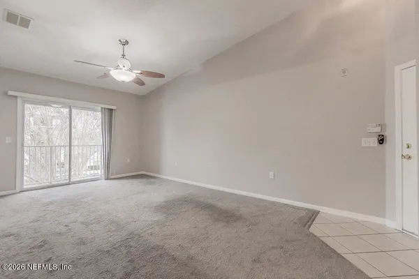 a view of kitchen with kitchen island and stainless steel appliances