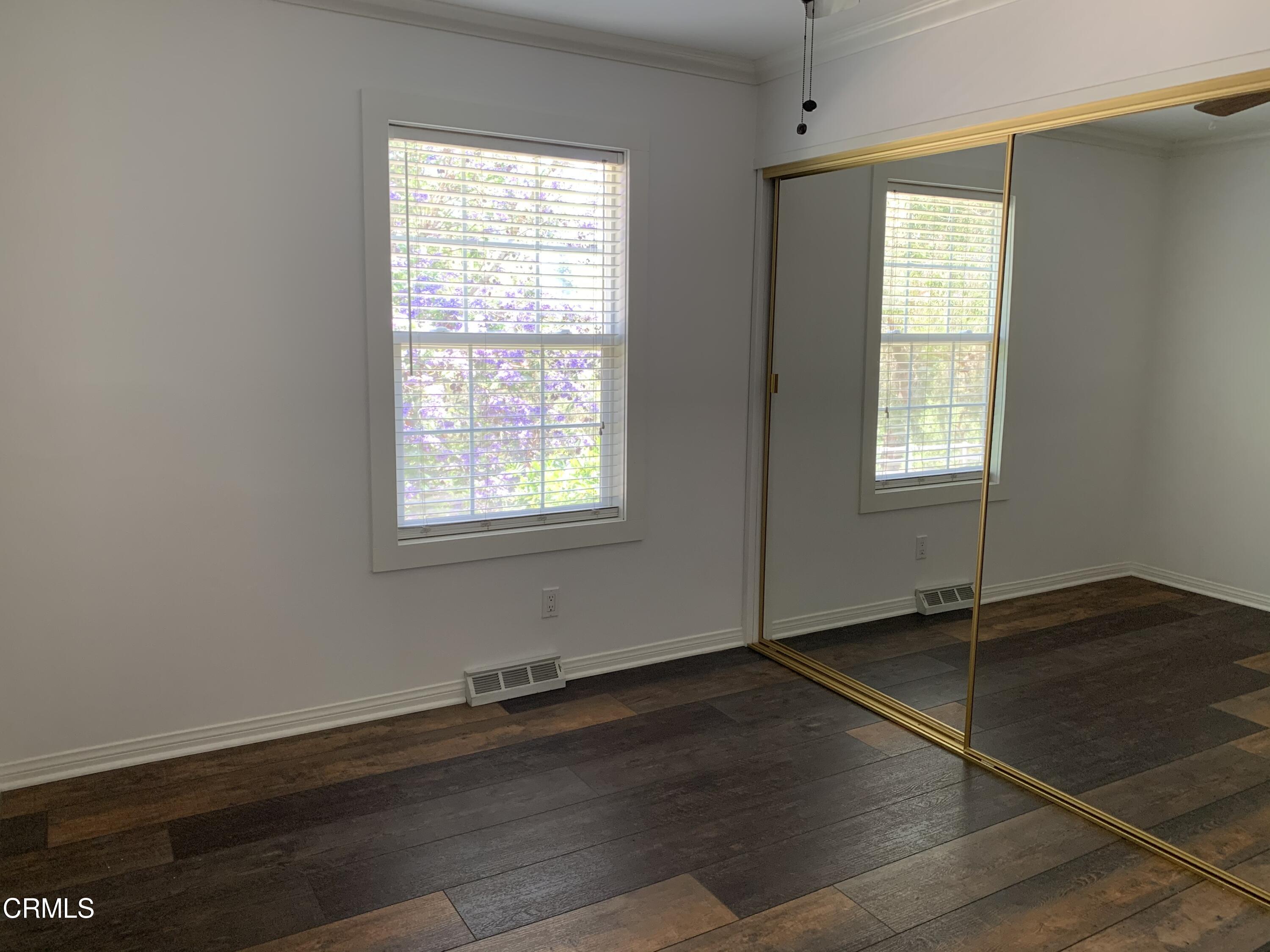 6009 La Cumbre Road Somis, CA 93066 - Photo 18 of 29 an empty room with wooden floor and windows